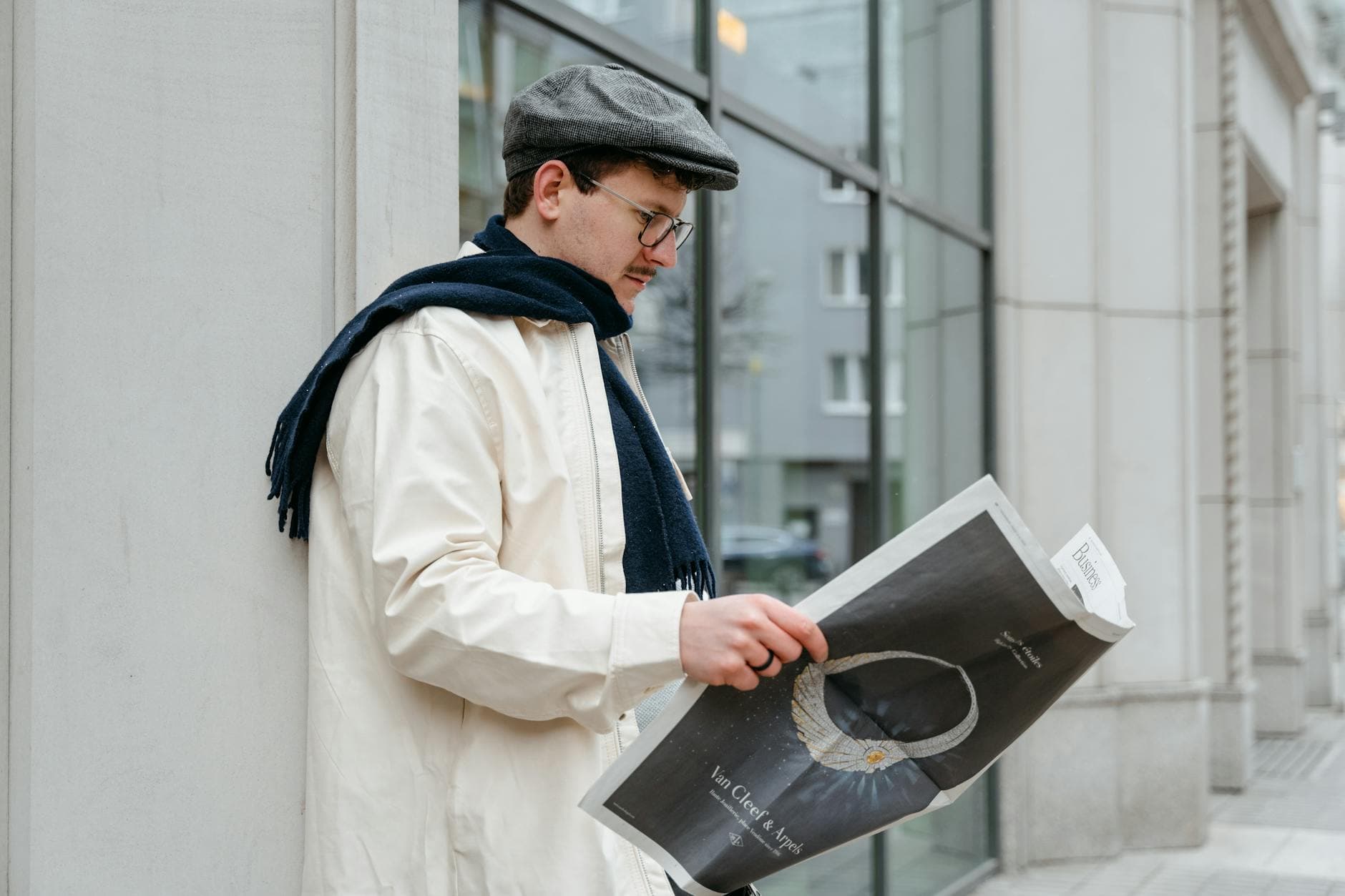 Close-up of a smartphone displaying ChatGPT app held over AI textbook.