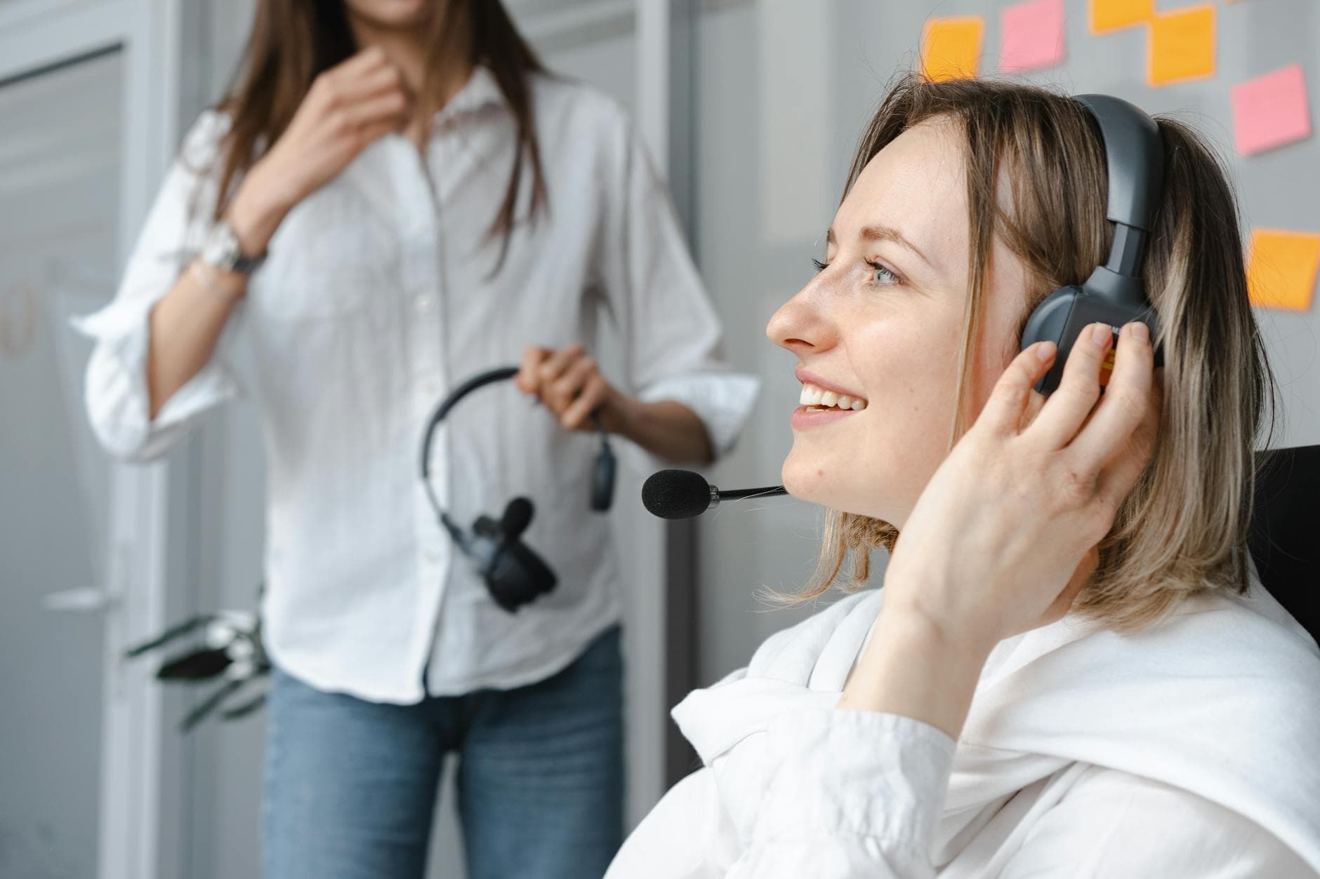 Caucasian woman working as a call center agent, engaging with customers over the phone.