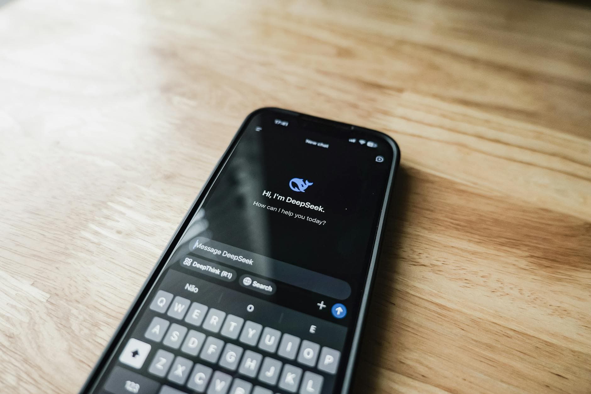 Scrabble tiles spelling out Google and Gemini on a wooden table, focusing on AI concepts.